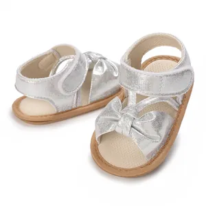 Shiny silver baby girl sandals featuring a cute bow and soft non-slip breathable sole.