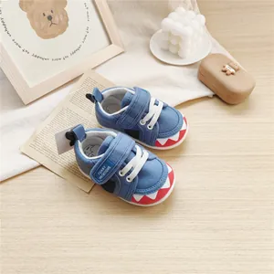 Macro view of cute blue cartoon shark themed baby walking shoes with soft flexible soles