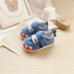 Detailed view of blue baby walking shoes with shark-teeth design and soft sole