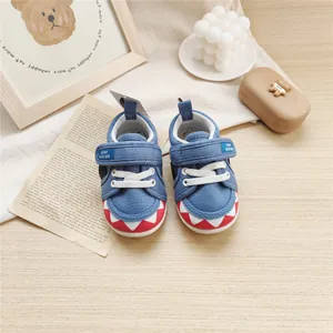 Detailed view of blue baby soft-sole walking shoes with cartoon shark teeth design
