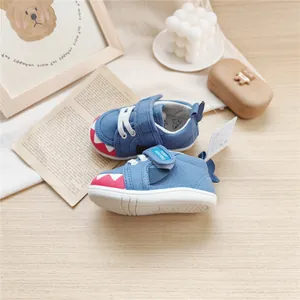 Detailed view of blue shark-themed toddler walking shoes featuring soft soles and cute fins