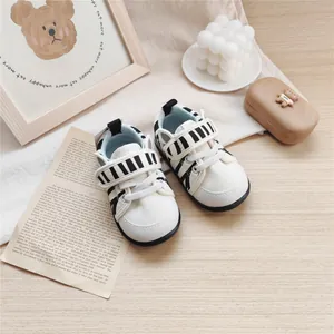 Detailed top view of baby soft-sole walking shoes with black zebra stripe patterns
