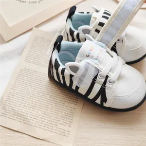Detailed view of zebra-striped baby walking shoes with cartoon ears and soft soles