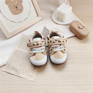 Detailed view of leopard print baby walking shoes featuring soft soles and velcro