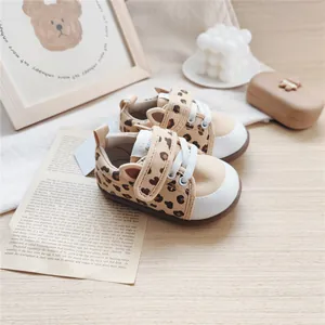 Close-up of leopard print baby toddler shoes with cute bear ears and soft rubber soles