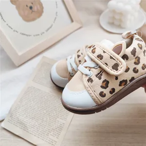 Close-up of baby leopard print walking shoes with cute animal ear Velcro strap