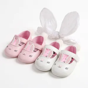 Detail of cute pink and white baby walking shoes with adorable bunny ear designs