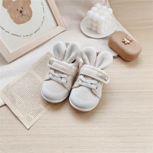 Adorable cream-colored baby soft-sole walking shoes with rabbit ears and canvas texture
