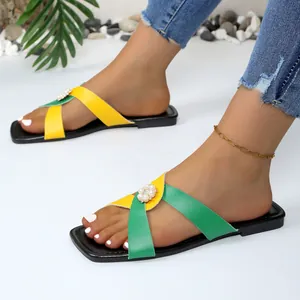Sandales plates d'été pour femmes avec brides croisées jaune et vert et fleur de perle.