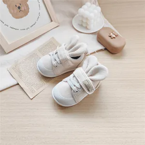 Detailed view of beige baby walking shoes featuring soft soles and cute bunny ear design