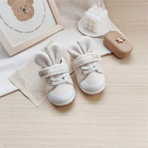 Adorable baby soft-sole walking shoes with cute rabbit ears in beige canvas design