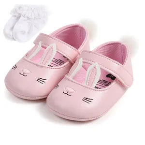 Detailed view of pink baby bunny princess shoes with white ruffle lace socks set