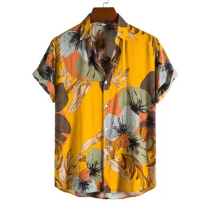 Detailed view of yellow Hawaiian short-sleeved shirt with tropical floral patterns