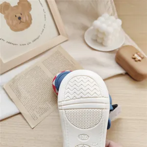 Close-up of anti-slip white soft sole for toddler walking shoes with size 13.0 mark.