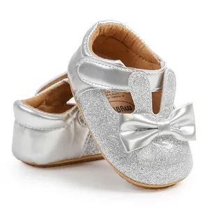 Close-up of silver glitter baby princess walking shoes with bunny ears and bow detail