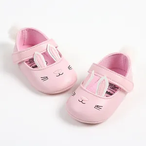 Close-up of pink baby walking shoes with cute rabbit ears and face design
