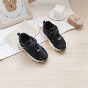 Detailed view of black MLW children's functional sneakers on a minimalist background