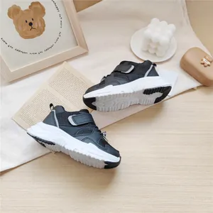 Detailed close-up of black children's functional sneakers with breathable mesh upper