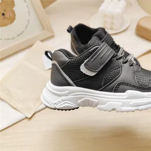 Side view of black children's functional sneakers with white chunky sole for boys
