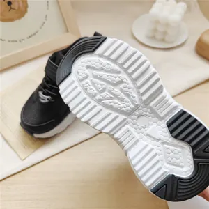 Detailed close-up of the anti-slip honeycomb sole on black children's sport shoes