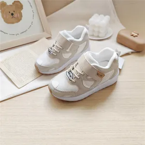Detailed view of MLW cream-colored functional sneakers for children on wooden surface