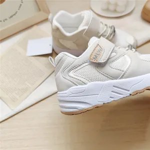 Close-up of beige children's functional sports shoes showing mesh and strap detail