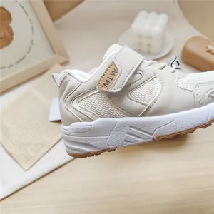 Macro view showing the breathable mesh and Velcro strap of the MLW children's sneaker