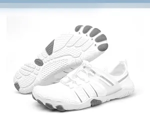 Detailed view of white minimalist five-finger water shoes with a non-slip sole texture