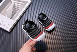 Detailed view of breathable fly-knit baby walking shoes with striped pattern