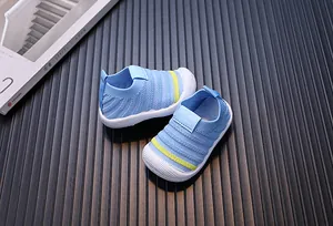 Detailed view of blue fly-knit toddler walking shoes with breathable mesh design.