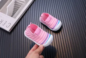 Close-up of pink breathable fly-knit baby toddler shoes with soft anti-slip white soles