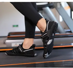Close-up view of breathable black water shoes worn on a treadmill for yoga and fitness.