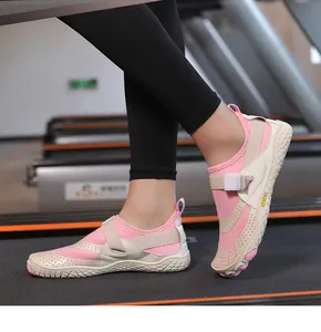 Close-up of pink breathable mesh water shoes with a velcro strap on a treadmill