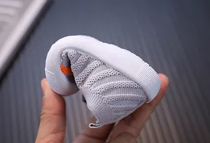 Detail view showing extreme flexibility and soft sole of the baby flyknit walking shoe