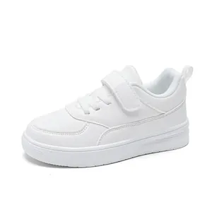 Classic all-white kids' low-top leather sneakers with adjustable hook-and-loop strap