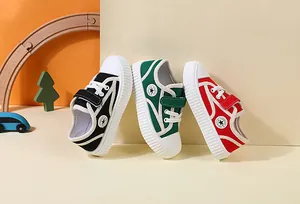 Detail view of three pairs of children's canvas sneakers in black, green, and red colors