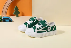 Detailed side view of green kids' canvas walking shoes featuring hook and loop closure