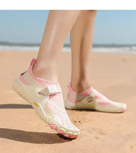 Close-up of pink breathable water shoes for beach and swimming activities on sand
