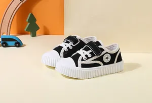 Detailed view of children's black canvas toddler shoes with star patch and thick ribbed white sole