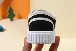 Rear view of black children's canvas shoe with thick white soft anti-slip rubber sole