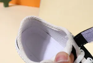 Close-up detail of breathable mesh insole inside children's black canvas toddler shoe