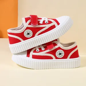 Vibrant red children's canvas sneakers with thick soft soles and easy velcro straps