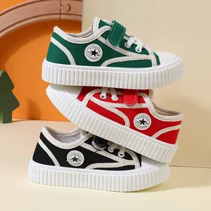 Stack of colorful children's canvas sneakers with soft soles for toddlers and kids