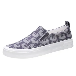 Comfortable men's slip-on canvas shoes featuring a grey bear pattern and white sole.