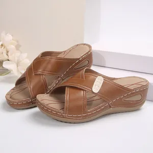 Vintage brown wedge sandals for women featuring elegant cross straps and contrast stitching