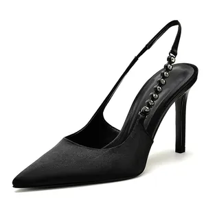 Elegant black satin pointed toe slingback pumps with rhinestone chain strap detail.