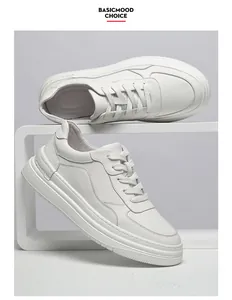 Detailed view of premium white leather sneakers for men with minimalist laces and foam sole.