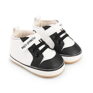 Detailed view of black and white baby prewalker shoes featuring magic prewalker text