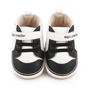 Detailed top view of black and white baby walking shoes with magic prewalker straps
