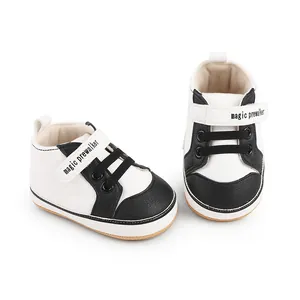 Detail of black and white baby prewalker shoes featuring magic prewalker velcro straps